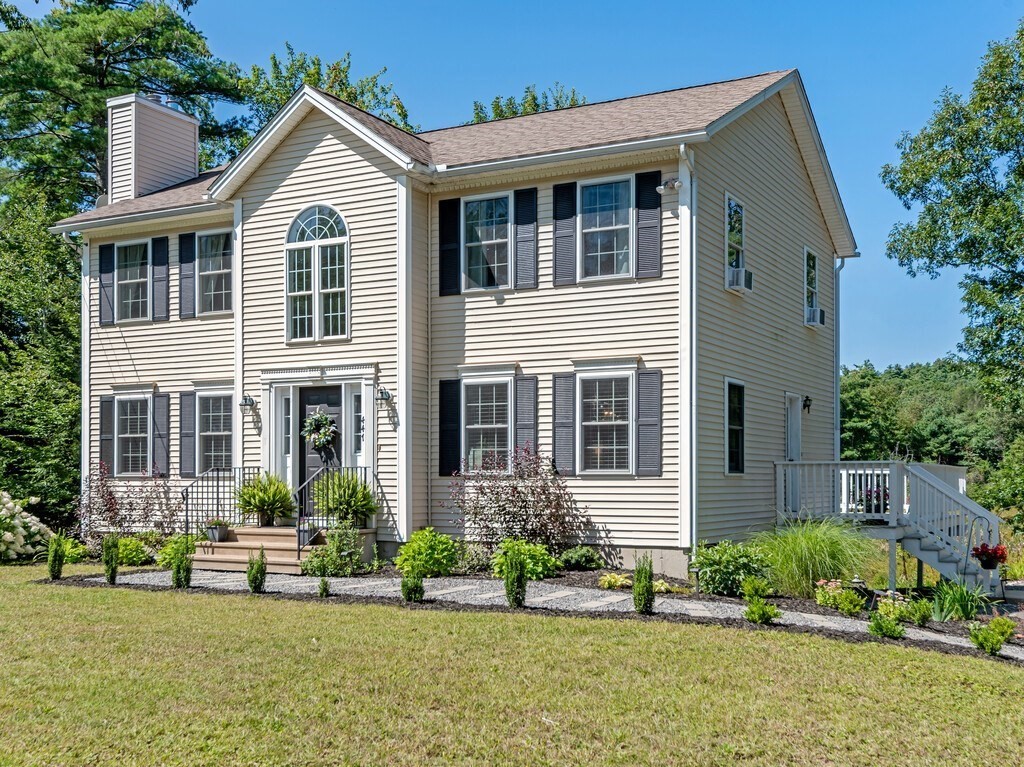 447 Ashby Road Ashburnham, MA 01430 - Photo 1 of 37 a front view of a house with a yard and plants