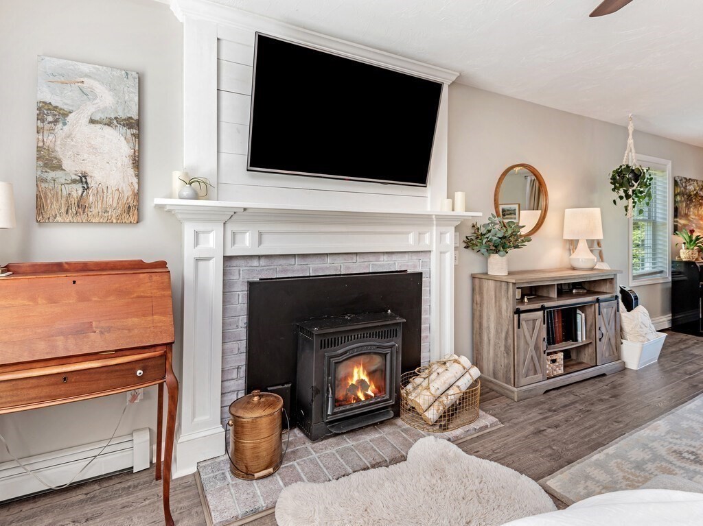 447 Ashby Road Ashburnham, MA 01430 - Photo 13 of 37 a living room with furniture a flat screen tv and a fireplace