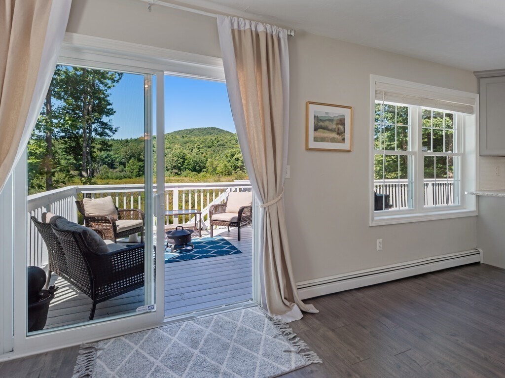 447 Ashby Road Ashburnham, MA 01430 - Photo 14 of 37 a view of a porch with furniture and a yard