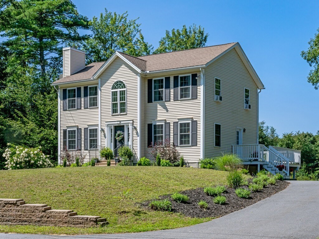 447 Ashby Road Ashburnham, MA 01430 - Photo 2 of 37 a front view of a house with a yard