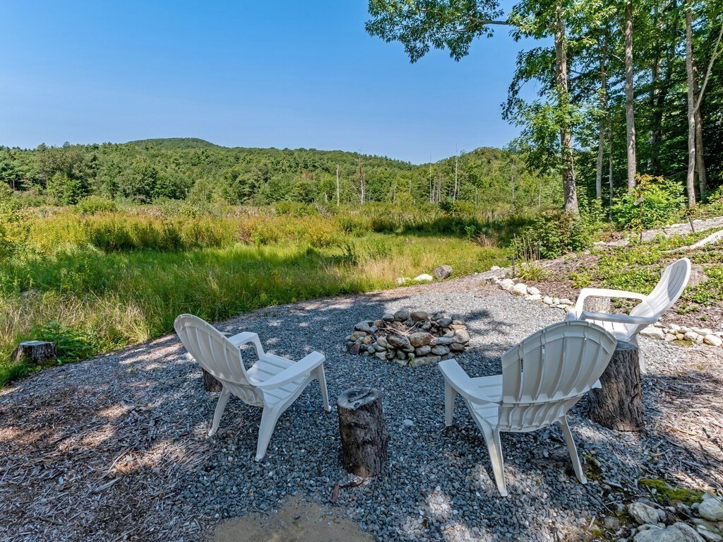447 Ashby Road Ashburnham, MA 01430 - Photo 30 of 37 a view of a lake with a table and a chairs