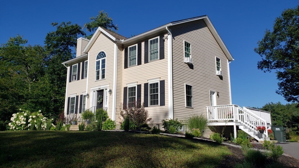447 Ashby Road Ashburnham, MA 01430 - Photo 3 of 37 a front view of a house with a yard