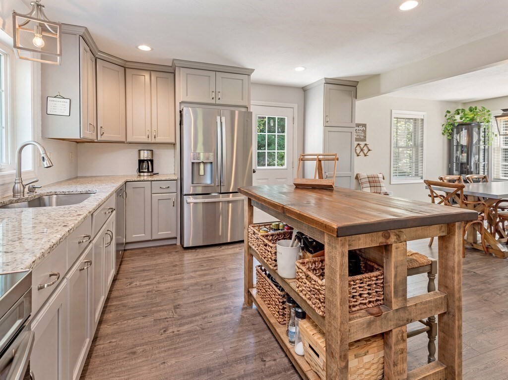 447 Ashby Road Ashburnham, MA 01430 - Photo 6 of 37 a kitchen with stainless steel appliances granite countertop a stove a sink dishwasher a refrigerator and white cabinets with wooden floor