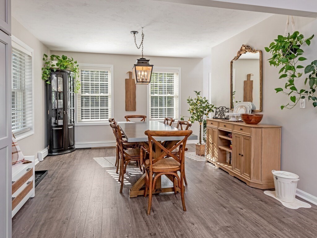 447 Ashby Road Ashburnham, MA 01430 - Photo 7 of 37 a view of a dining room with furniture and wooden floor