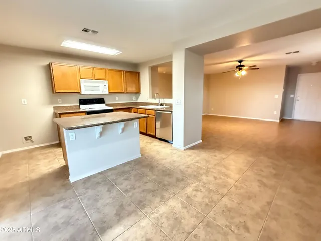 a kitchen with stainless steel appliances granite countertop a sink and a stove