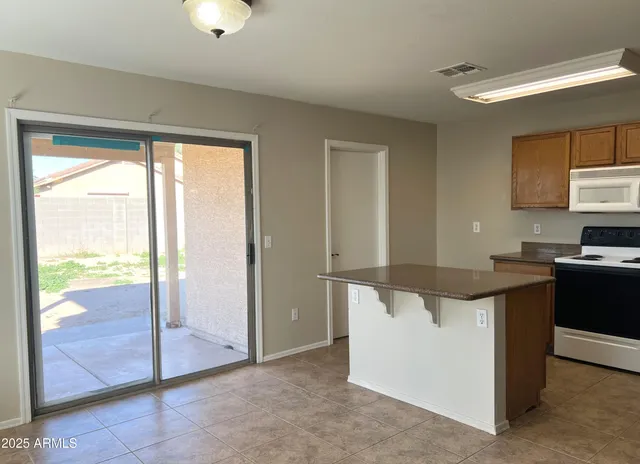 a kitchen with stainless steel appliances granite countertop a stove and a refrigerator