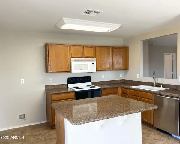 a kitchen with stainless steel appliances granite countertop a sink stove and window