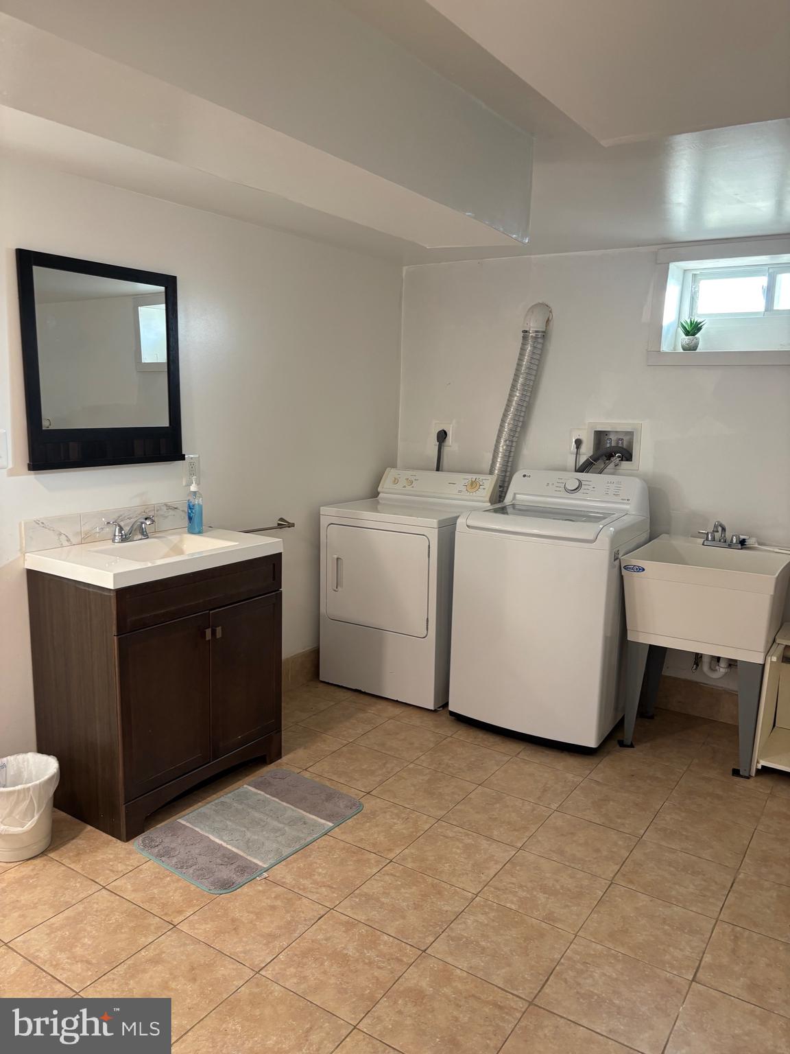 2483 Jericho Road Flint Hill, VA 22627 - Photo 11 of 18 a utility room with a sink a toilet and a mirror