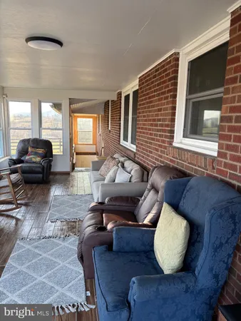 a view of a terrace with lawn chairs and mountain view