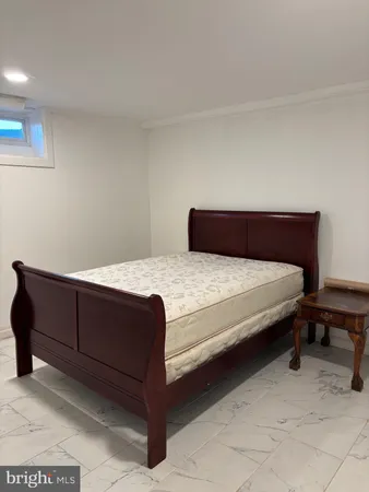 a bedroom with a bed and a chair