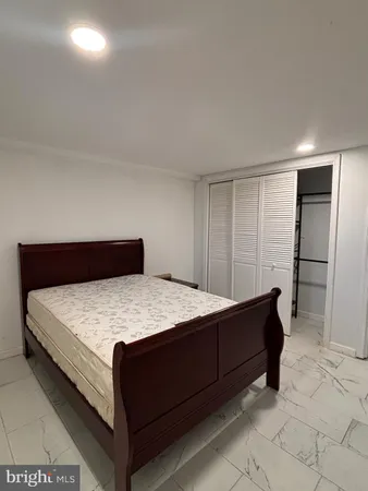 a bedroom with a bed and a dresser