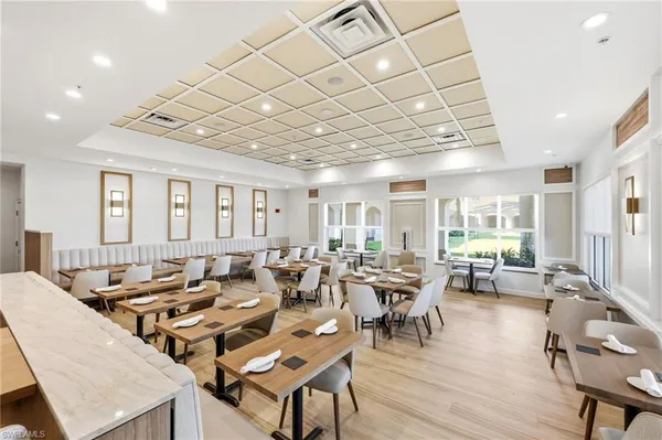 a very nice looking living room with a large dining table and a large window with wooden floor