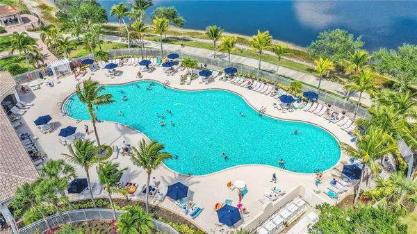 an aerial view of a swimming pool with a yard