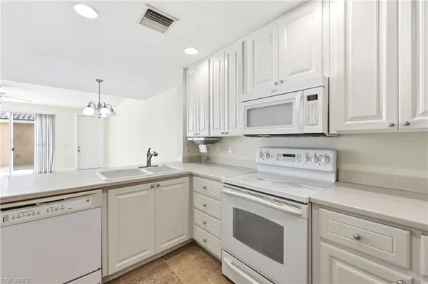 a kitchen with appliances cabinets and a sink