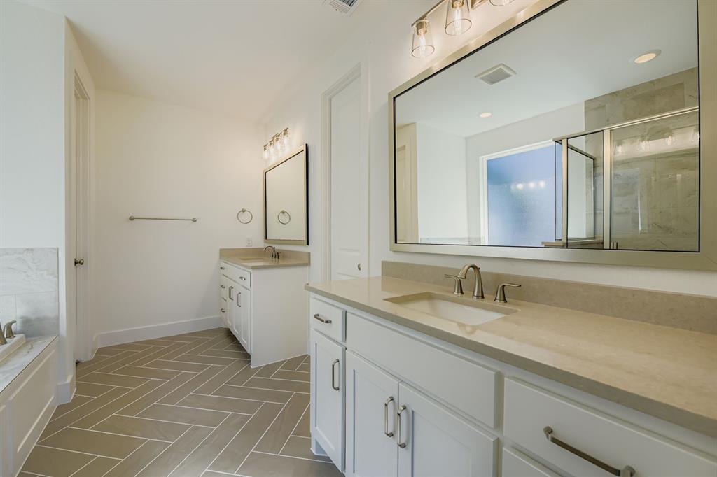 2124 Ten Mile Crk Road Celina, TX 75009 - Photo 16 of 30 a spacious bathroom with a double vanity sink a mirror and a bathtub