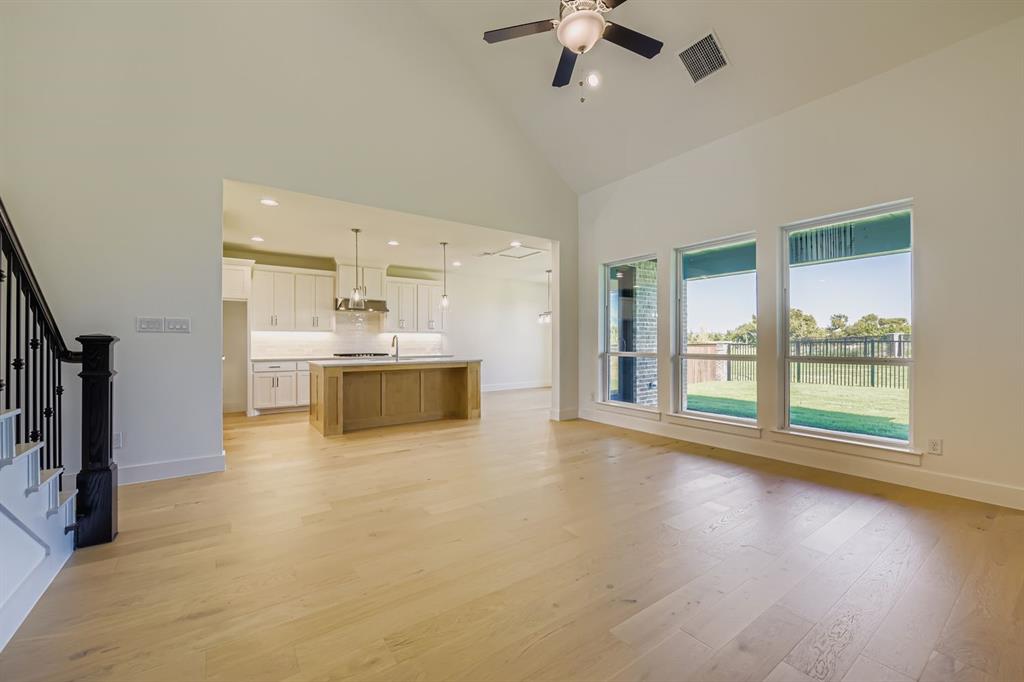 2124 Ten Mile Crk Road Celina, TX 75009 - Photo 5 of 30 a view of a kitchen with a stove wooden floor and a window
