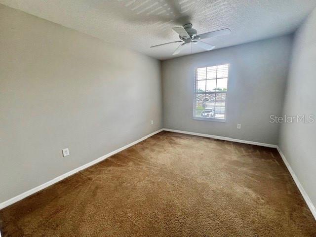 2749 Callaway Lane Kissimmee, FL 34744 - Photo 17 of 30 an empty room with windows and ceiling fan