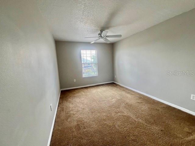 2749 Callaway Lane Kissimmee, FL 34744 - Photo 18 of 30 an empty room with a window and a fan