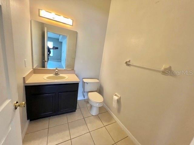 2749 Callaway Lane Kissimmee, FL 34744 - Photo 26 of 30 a bathroom with a sink a toilet and mirror