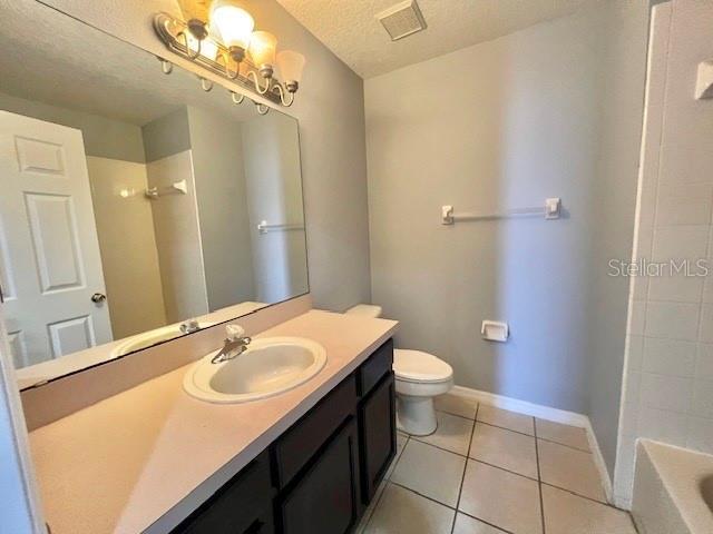 2749 Callaway Lane Kissimmee, FL 34744 - Photo 27 of 30 a bathroom with a sink a toilet a mirror and vanity