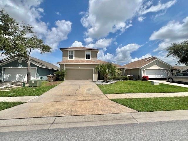2749 Callaway Lane Kissimmee, FL 34744 - Photo 3 of 30 a front view of a house with a yard