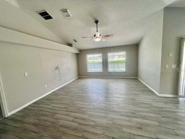 2749 Callaway Lane Kissimmee, FL 34744 - Photo 8 of 30 wooden floor in an empty room with a window