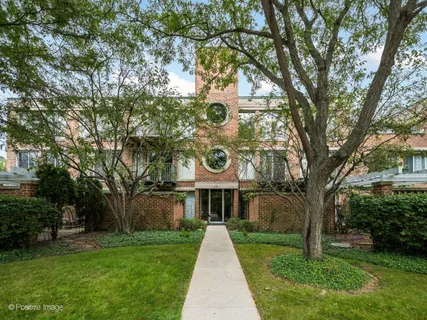 a front view of a house with yard and green space