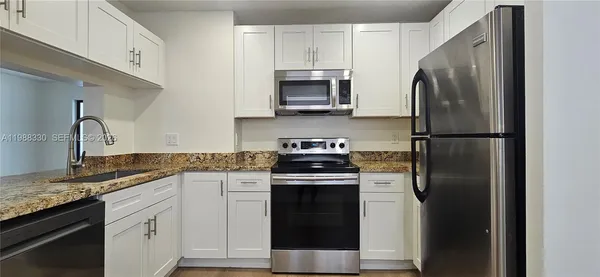 a kitchen with a sink and a refrigerator