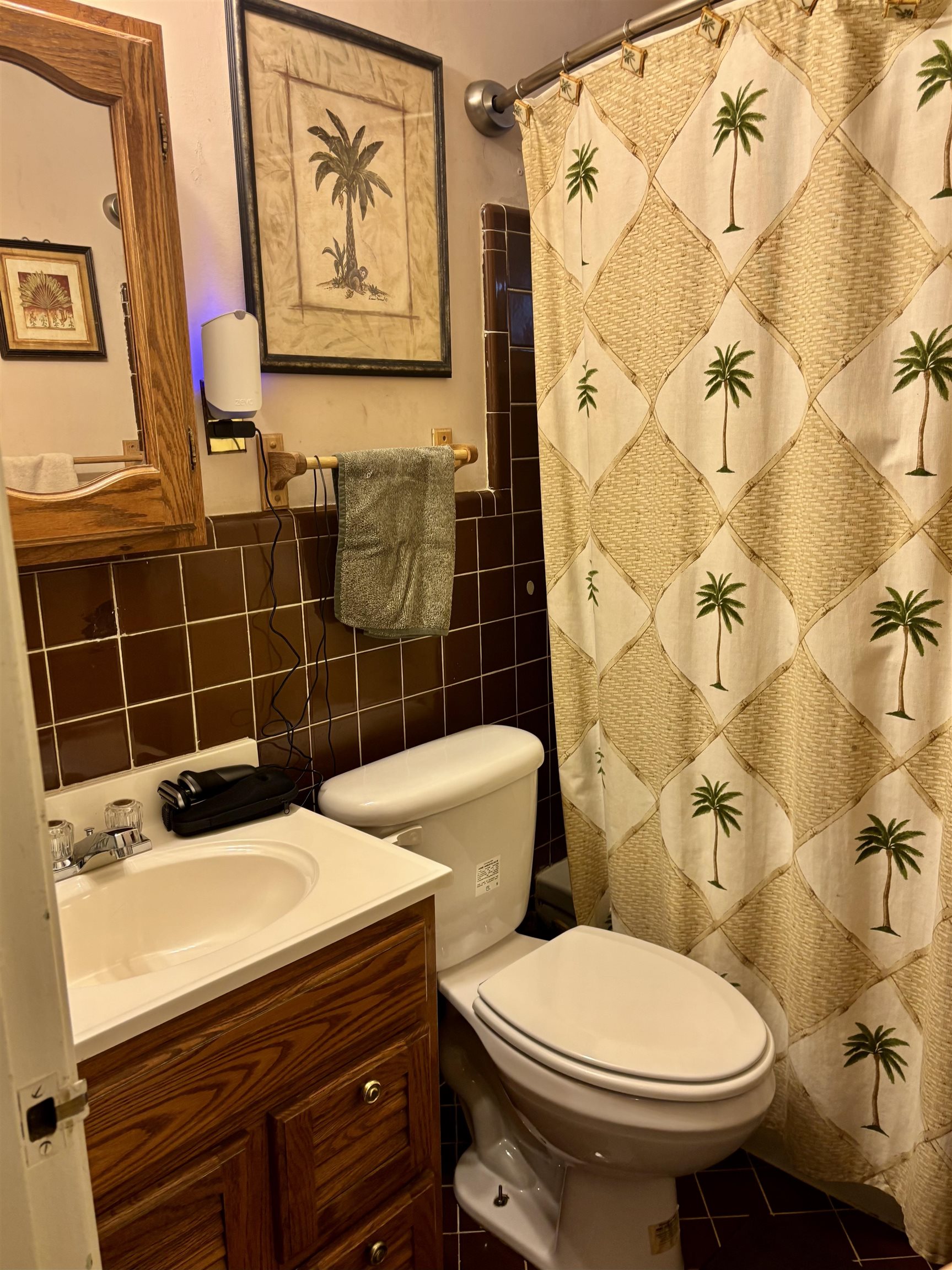 496 Chalmers Road Memphis, TN 38120 - Photo 16 of 20 Bathroom with tile patterned flooring, tile walls, a shower with shower curtain, vanity, and toilet