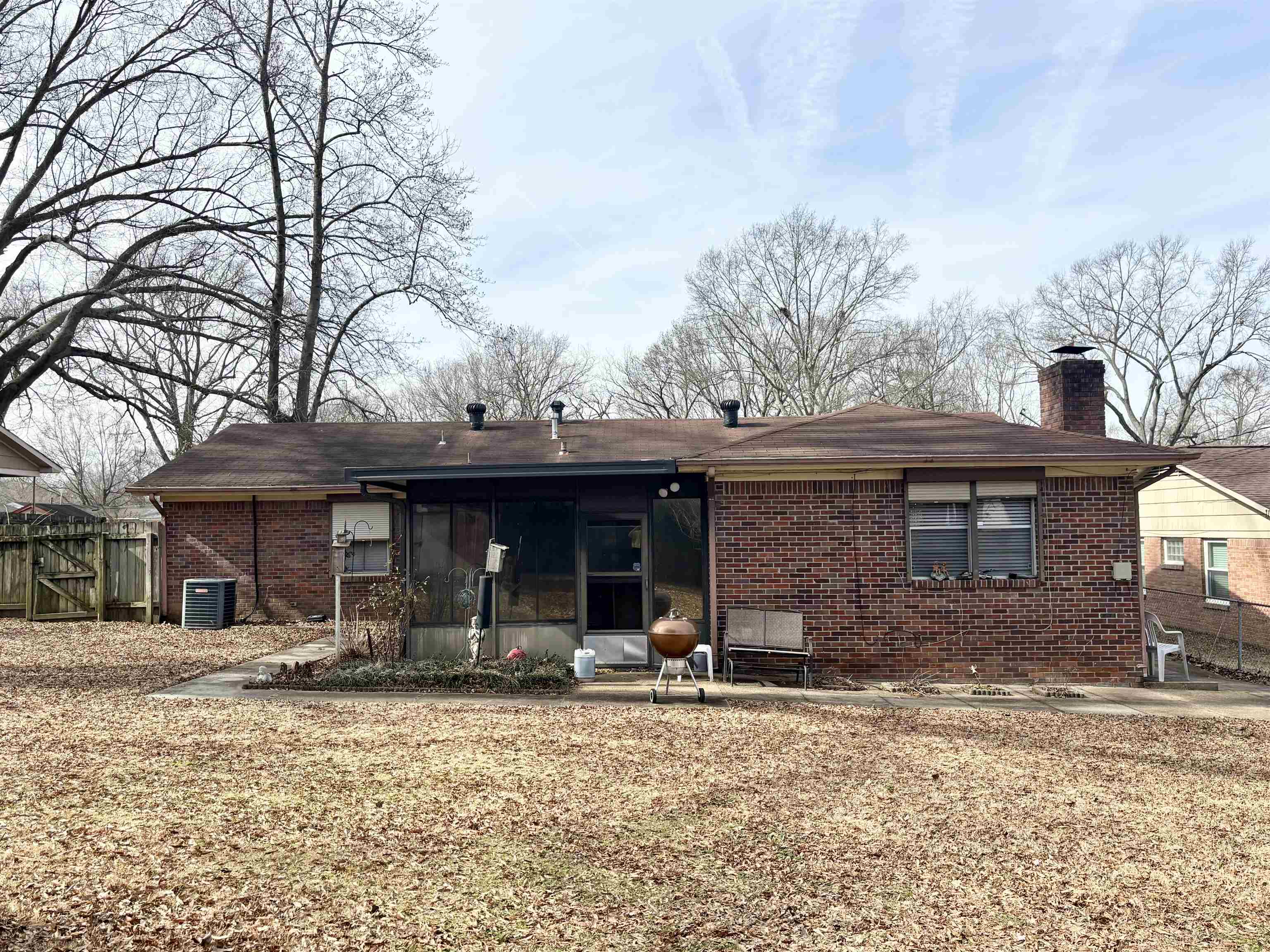 496 Chalmers Road Memphis, TN 38120 - Photo 17 of 20 Rear view of house featuring central AC and a sunroom