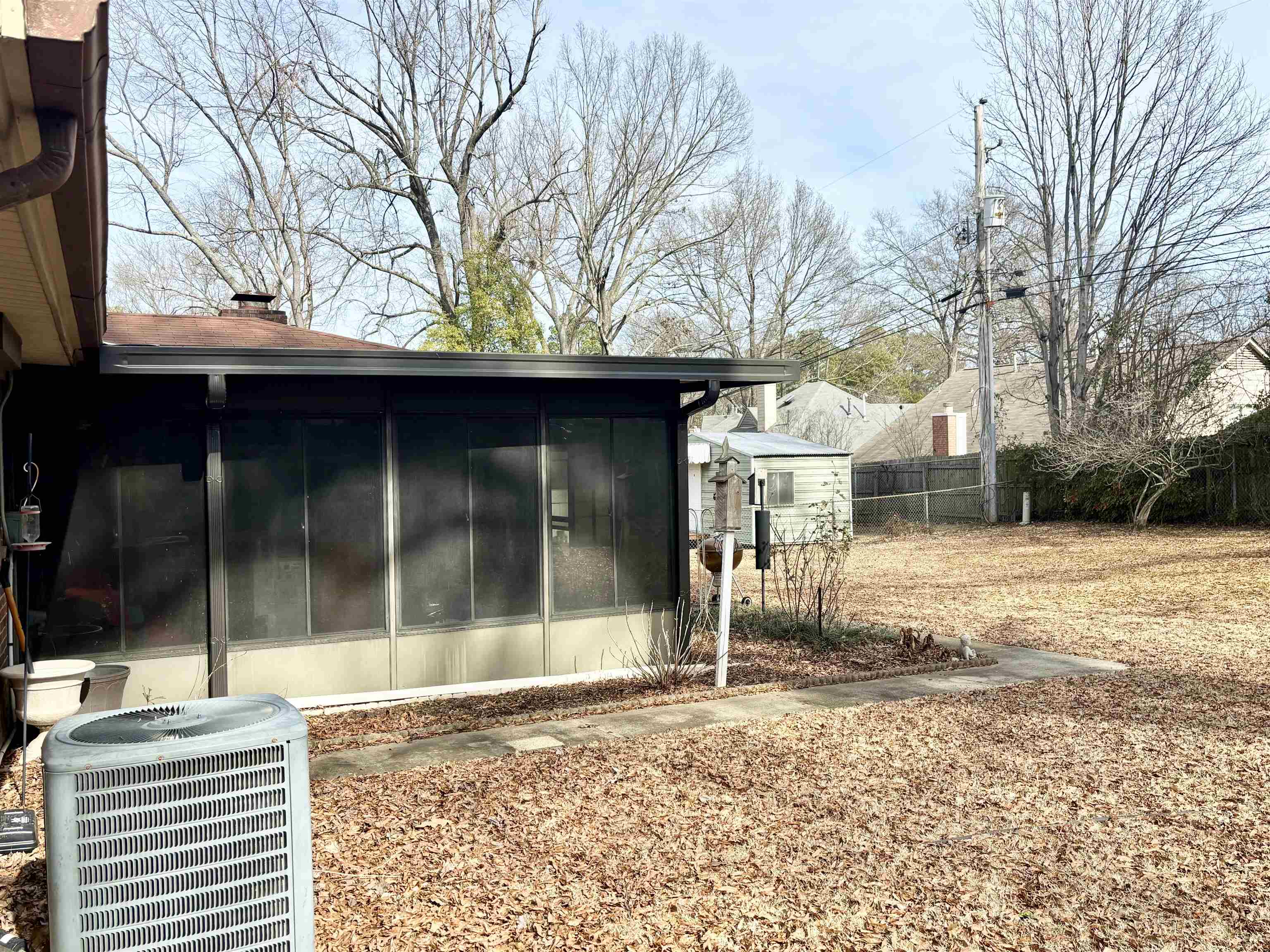 496 Chalmers Road Memphis, TN 38120 - Photo 20 of 20 View of side of home with central AC and a sunroom