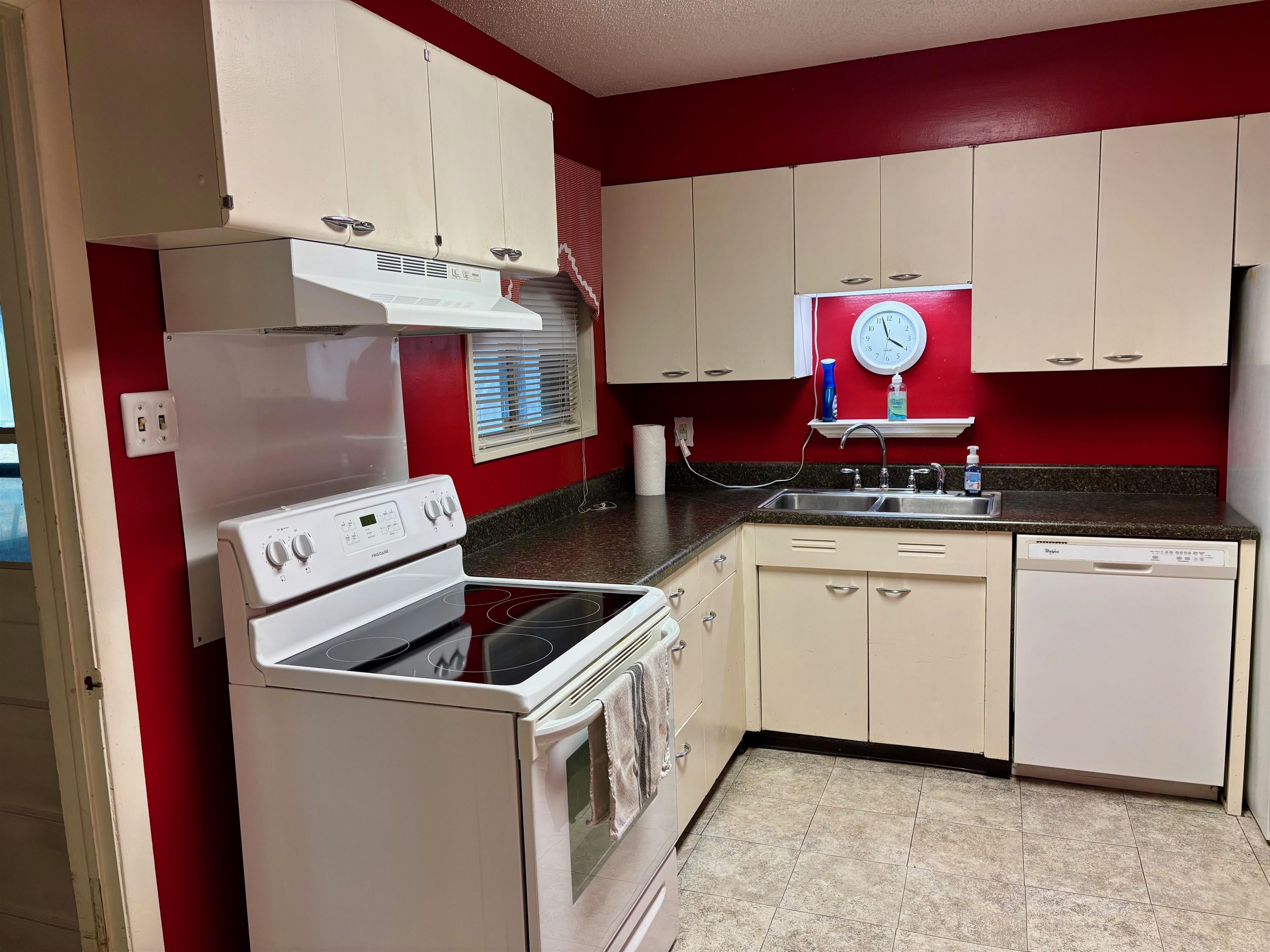 496 Chalmers Road Memphis, TN 38120 - Photo 9 of 20 Kitchen with a sink, dark countertops, under cabinet range hood, and white appliances