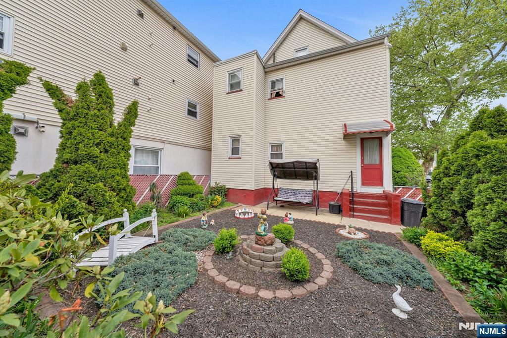 79 Washington Street Harrison, NJ 07029 - Photo 23 of 25 a front view of a house with garden
