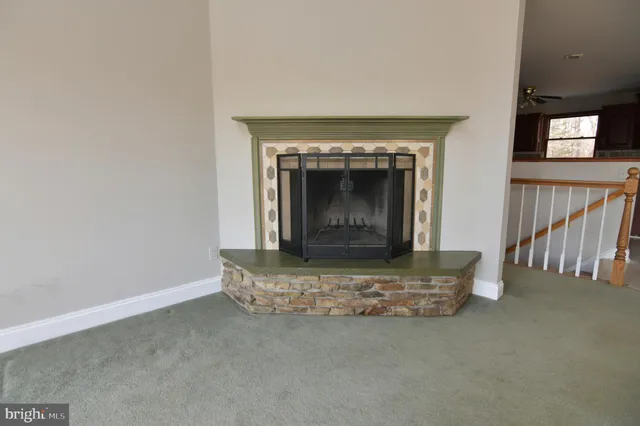 a kitchen with granite countertop a sink stainless steel appliances and window