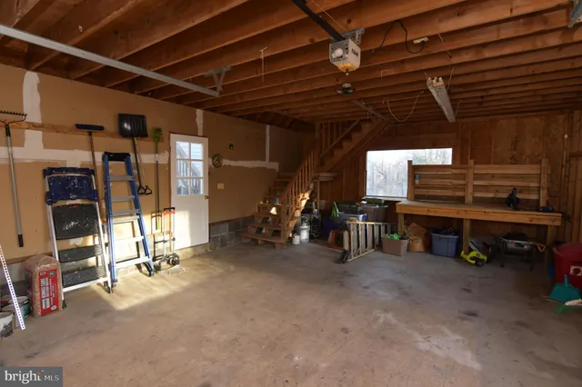 a view of a house with a big yard and large trees