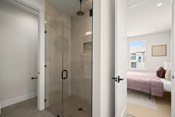 a bedroom with a bed and a glass door