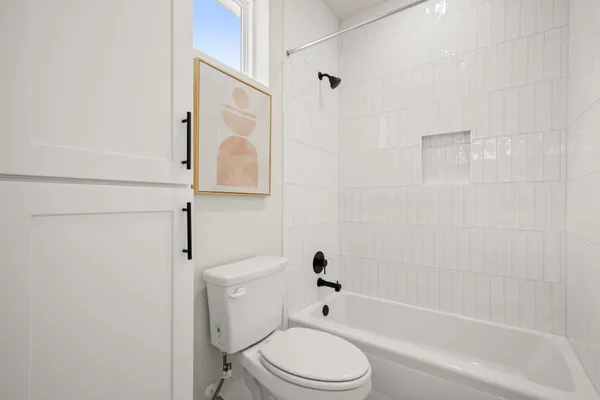 a bathroom with a toilet and a bathtub