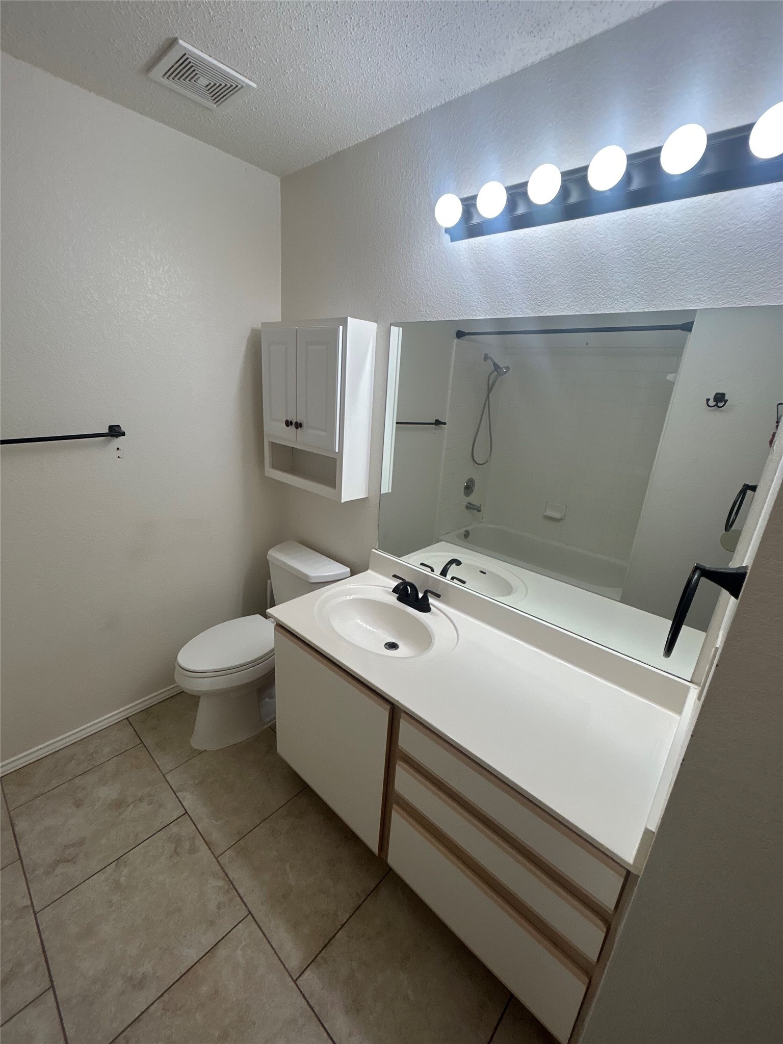 7229 Aldea Drive, Unit B Austin, TX 78745 - Photo 5 of 13 a bathroom with a sink a toilet and mirror