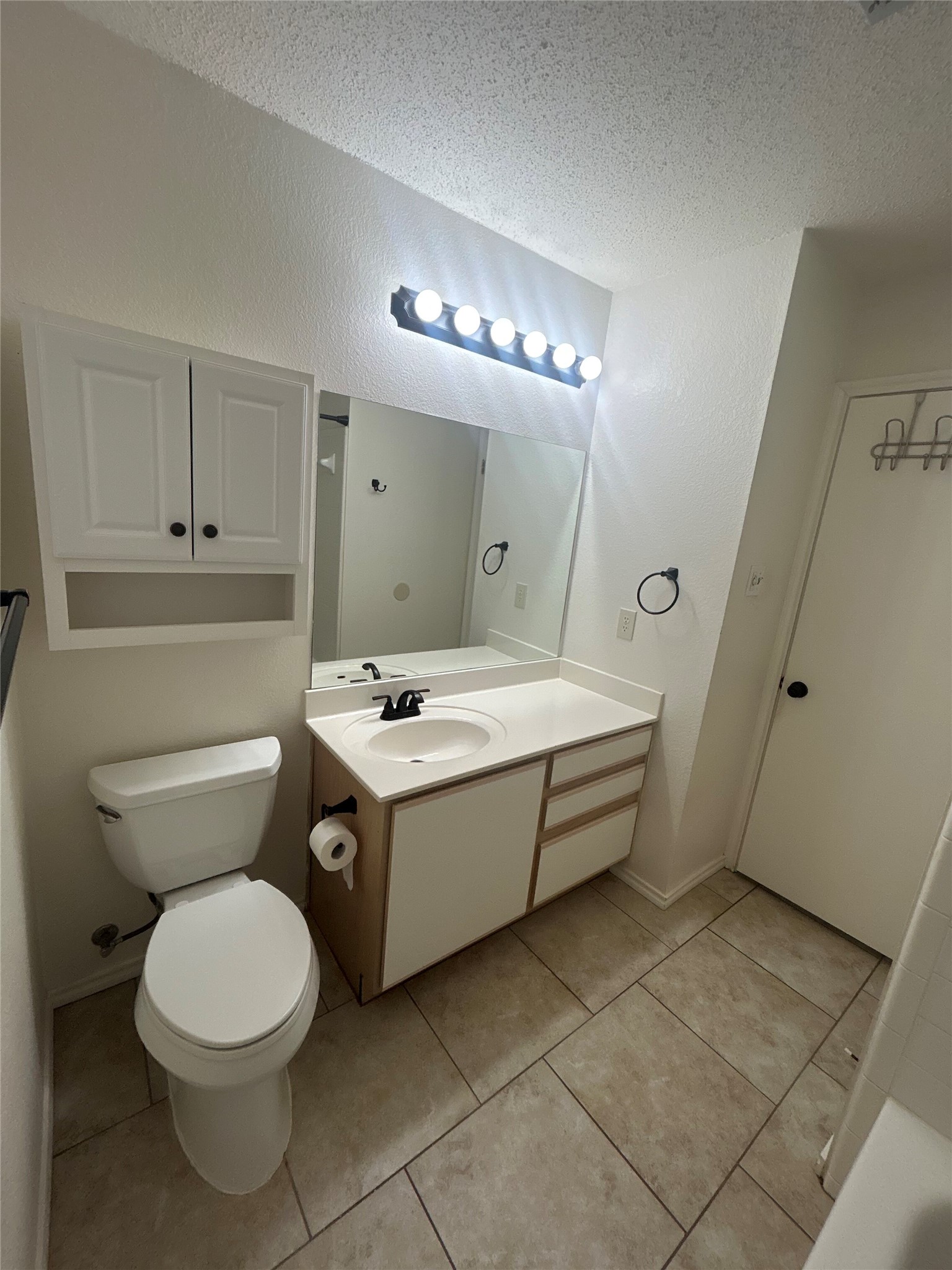 7229 Aldea Drive, Unit B Austin, TX 78745 - Photo 6 of 13 a bathroom with a sink a toilet and mirror