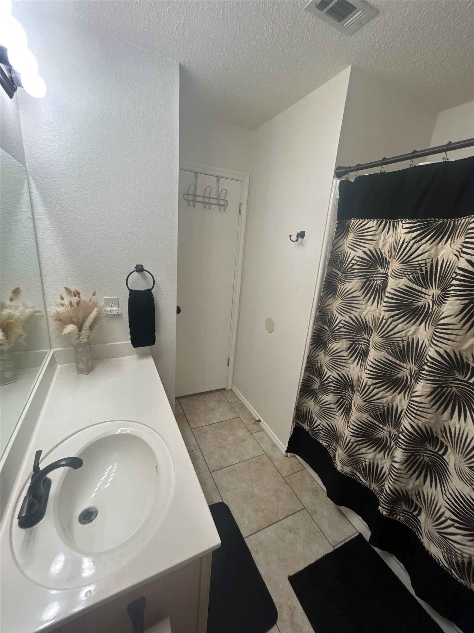 7229 Aldea Drive, Unit B Austin, TX 78745 - Photo 8 of 13 a bathroom with a sink and mirror