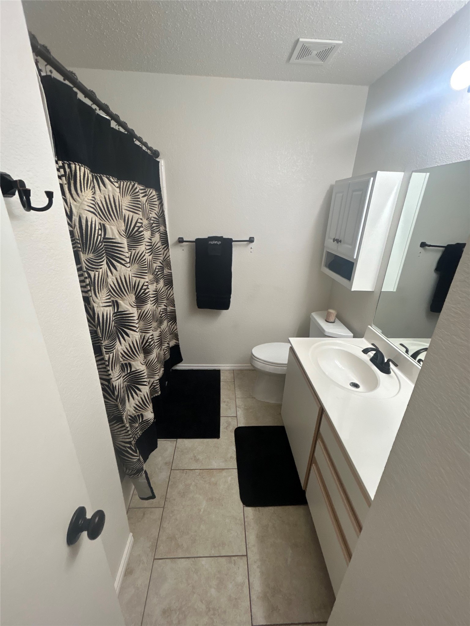 7229 Aldea Drive, Unit B Austin, TX 78745 - Photo 9 of 13 a bathroom with a sink and a mirror