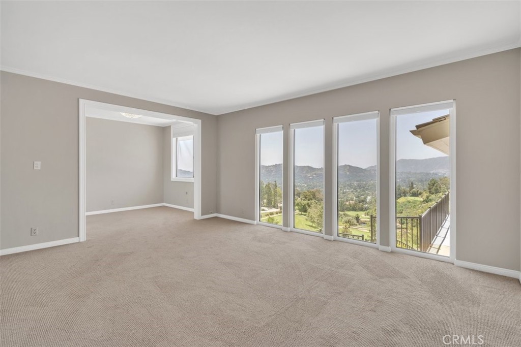 5441 Burning Tree Drive La Canada Flintridge, CA 91011 - Photo 12 of 32 a view of an empty room with windows and city view
