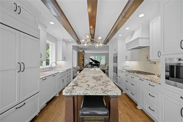 a view of kitchen with sink microwave and refrigerator
