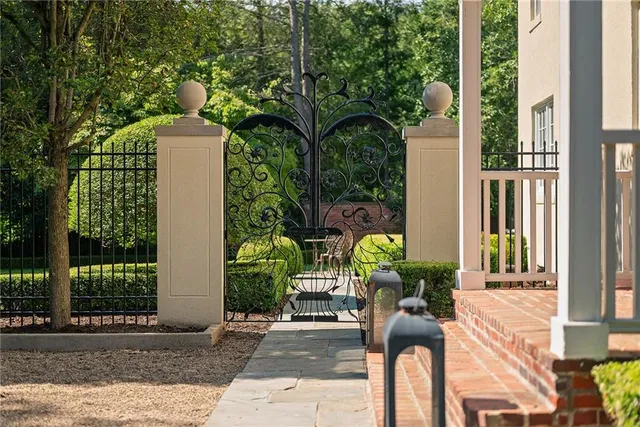a view of potted plants and a small yard in front of a house