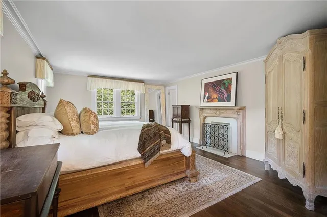 a bedroom with a bed and a fireplace