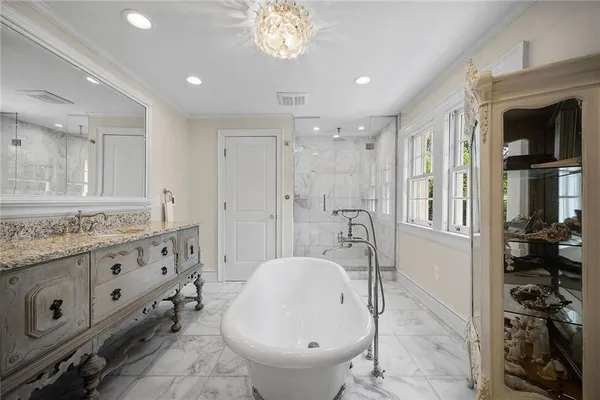 a bathroom with a granite countertop sink a toilet a shower and a mirror