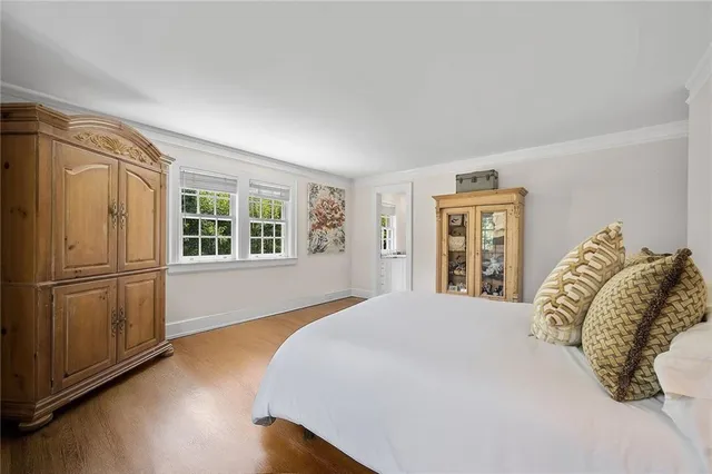 a large bed sitting in a bedroom next to a window