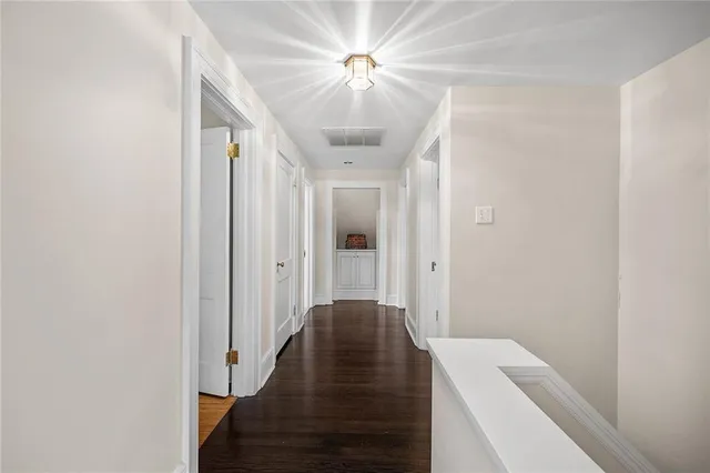 a view of a hallway with a chandelier and a ceiling fan