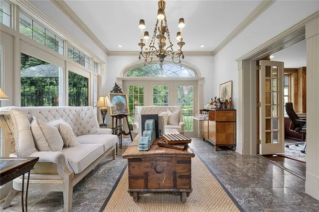 a living room with furniture or chandelier and a large window