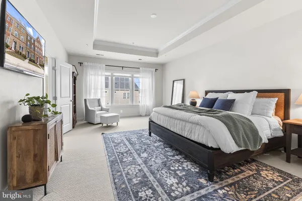 a bedroom with a large bed couch and a window
